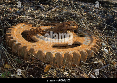 An old scaly reddish-brown rusty ship`s gear cog on Brougty Ferry beach in Dundee Scotland UK Stock Photo
